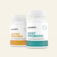 Two bottles of Yeastrix supplements: "Active Enzymes" with 60 vegetarian capsules, and "Daily Probiotic" with delayed release, also 60 vegetarian capsules, placed side by side.