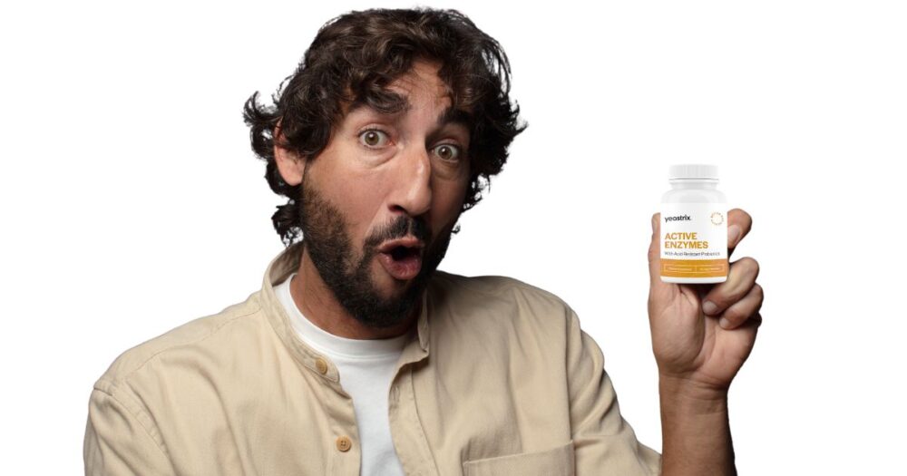 Man holding a bottle of Yeastrix Active Enzymes capsules, showing curiosity and interest in gut health