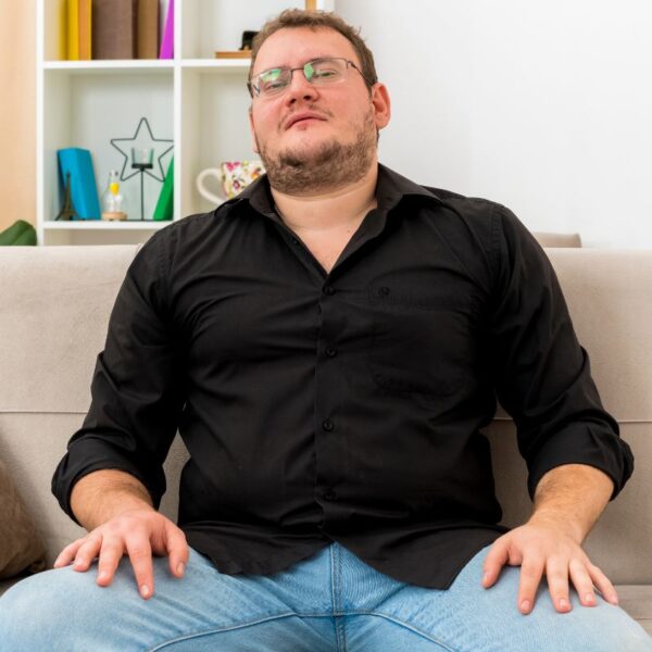Confident man sitting in chair practicing deep breathing exercises to improve poor circulation symptoms and digestive health