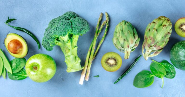 Broccoli, kiwifruit, asparagus, green apple and artichoke displayed as spring foods for candida diet support