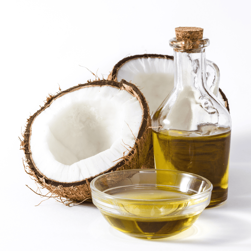 pic of a coconu opened and a bowl and jug of coconut oil which is where the caprylic acid comes from