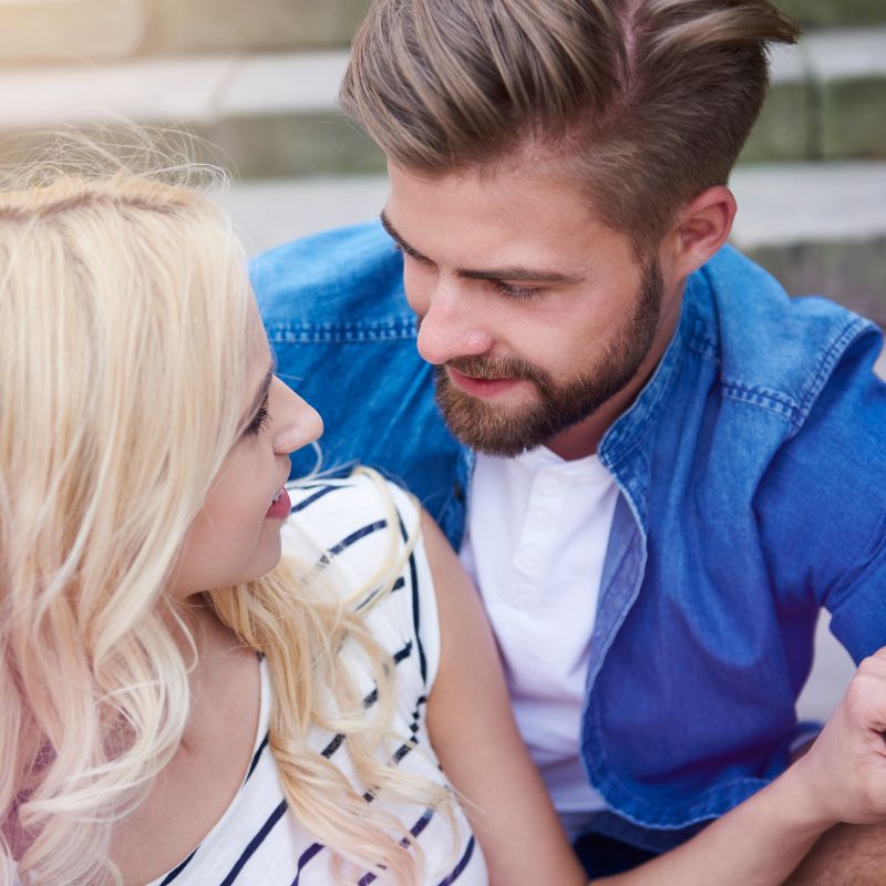 woman with blonde hair and well groomed male speaking intimately about whether candida is sexually transmitted
