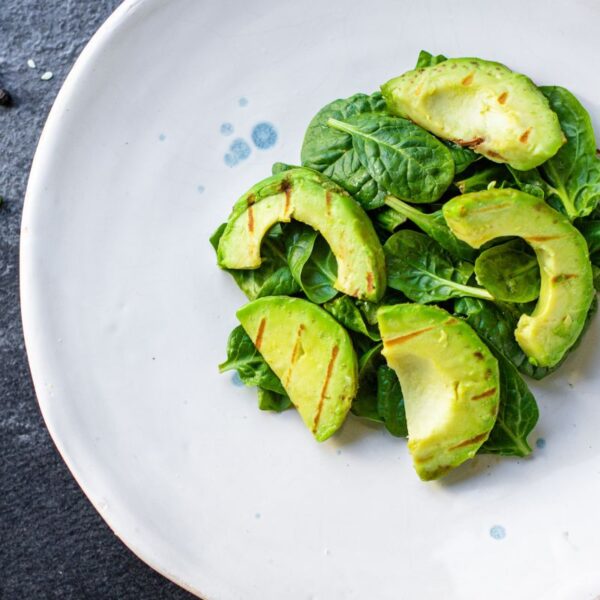 avocado slices on a white plate - candida and fats